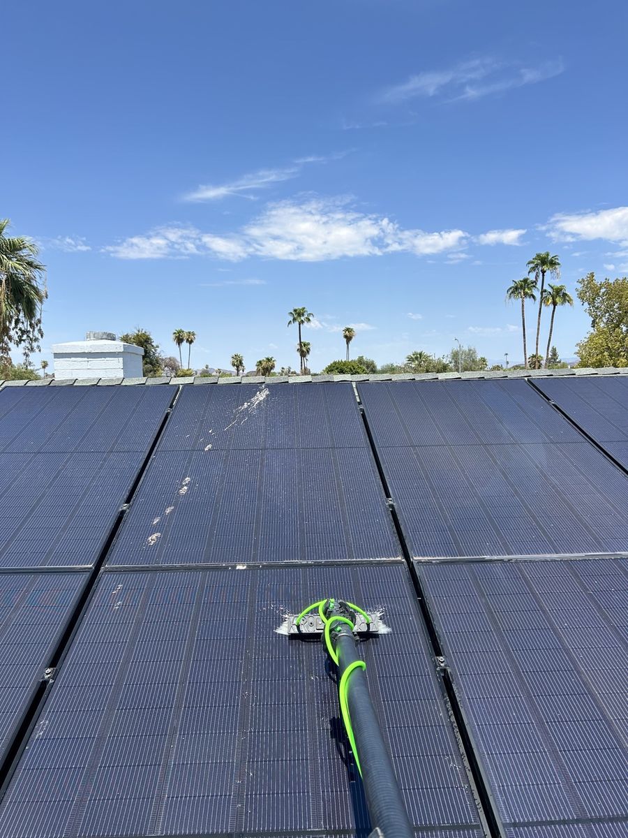 Water-fed brush cleaning dirty solar panels